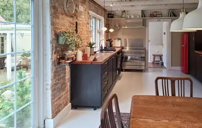 a kitchen with a brick wall and a table at Pet Friendly Home In Roslev With Wifi in Roslev