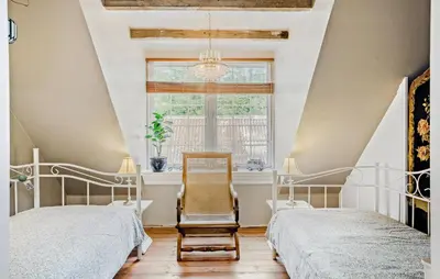 a bedroom with two beds and a chair and a window at Pet Friendly Home In Roslev With Wifi in Roslev