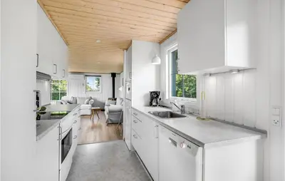 a kitchen with white walls and a wooden ceiling at Beautiful Home In Vinderup With Kitchen in Vinderup