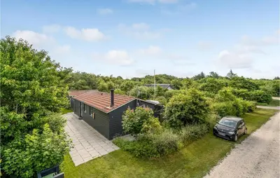 an overhead view of a black house with a car parked in the yard at Beautiful Home In Vinderup With Kitchen in Vinderup