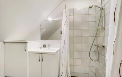 a white bathroom with a sink and a shower at Stunning Apartment In Lemvig With Wifi in Lemvig