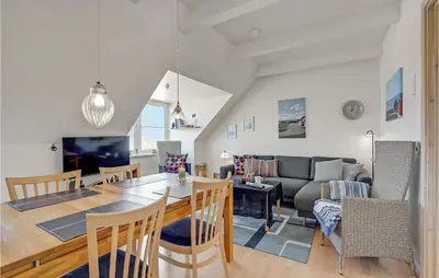 a dining room and living room with a table and chairs at Stunning Apartment In Lemvig With Wifi in Lemvig