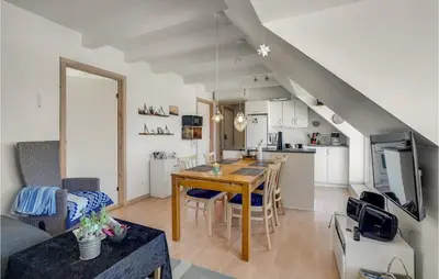a kitchen and living room with a table and chairs at Stunning Apartment In Lemvig With Wifi in Lemvig