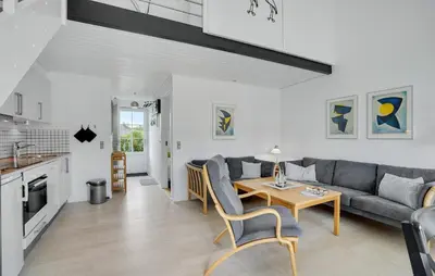 a living room with a couch and a table at Agger Havn Feriecenter in Vestervig