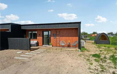 a small house with an orange and black exterior at 3 Bedroom Amazing Home In Thisted in Thisted