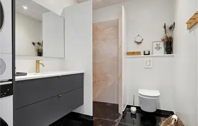 a white bathroom with a sink and a toilet at 3 Bedroom Amazing Home In Thisted in Thisted