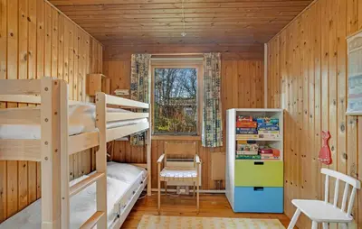 a bedroom with two bunk beds and a refrigerator at 3 Bedroom Cozy Home In Spøttrup in Spottrup