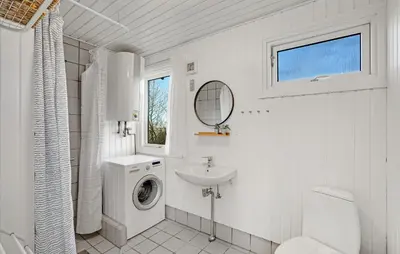 a white bathroom with a washing machine and a sink at 3 Bedroom Cozy Home In Spøttrup in Spottrup