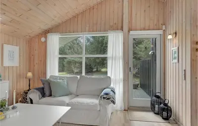 a living room with a couch and a window at 3 Bedroom Amazing Home In Pandrup in Pandrup