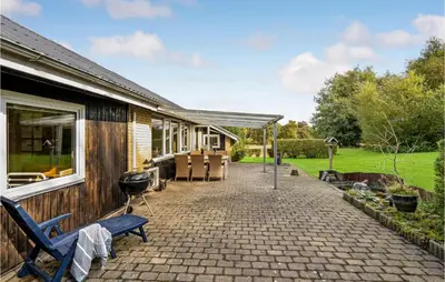 a patio of a house with chairs and a grill at Lovely Home In Roslev With Wifi in Roslev