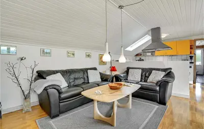 a living room with a couch and a table at Lovely Home In Roslev With Wifi in Roslev
