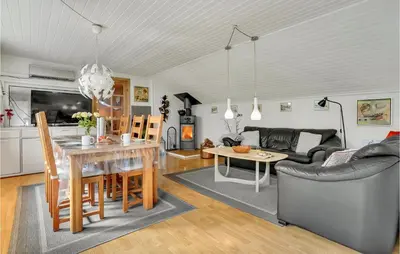 a kitchen and living room with a table and a couch at Lovely Home In Roslev With Wifi in Roslev