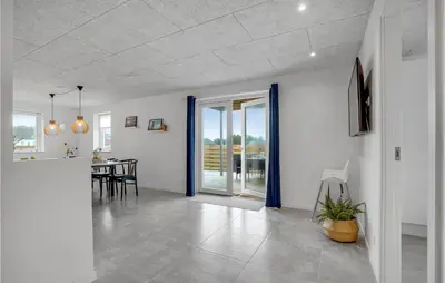a living room with a table and a dining room at Lovely Home In Thisted in Thisted