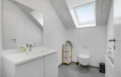 a white bathroom with a sink and a window at Lovely Home In Thisted in Thisted