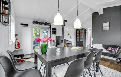 a dining room with a table and chairs at Cozy Home In Roslev With Wifi in Roslev