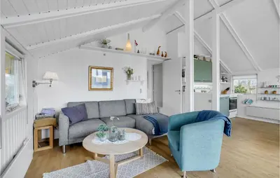 a living room with a couch and a table at Lovely Home In Roslev With Kitchen in Roslev