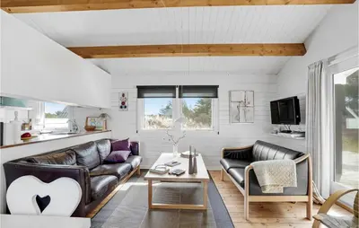 a living room with a couch and a table at 2 Bedroom Beautiful Home In Thisted in Thisted