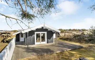 a small black house with a wooden deck at 2 Bedroom Beautiful Home In Thisted in Thisted