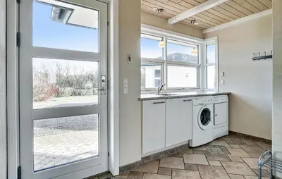 a laundry room with a washing machine and a window at Stunning Home In Vestervig With Sauna in Vestervig