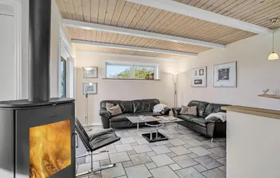 a living room with a fireplace and couches at Stunning Home In Vestervig With Sauna in Vestervig