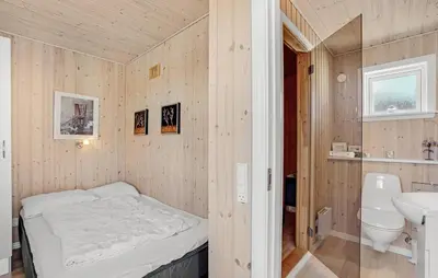 a small bedroom with a bed and a sink at Stunning Home In Vestervig With Sauna in Vestervig