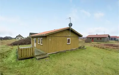 a small house in a field with a yard at Gorgeous Home In Harboøre With Wifi in Harboør