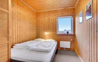 a small room with two beds in a wooden wall at Gorgeous Home In Harboøre With Wifi in Harboør