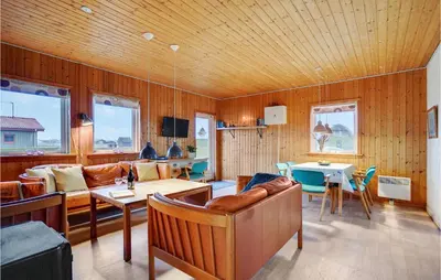 a living room with a couch and a table at Gorgeous Home In Harboøre With Wifi in Harboør