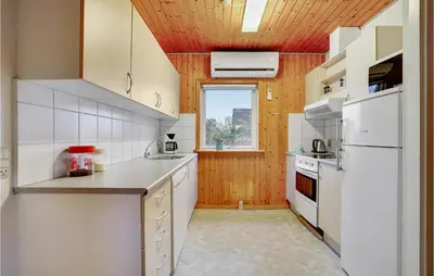 a kitchen with white appliances and a wooden ceiling at Gorgeous Home In Harboøre With Wifi in Harboør
