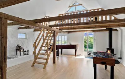 a loft bed with a ladder in a room with a piano at Cozy Home In Nykøbing M With Kitchen in Tæbring