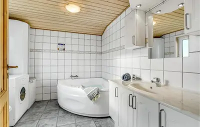 a white bathroom with a tub and a sink at Awesome Home In Lemvig With Wifi in Lemvig