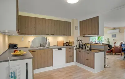 a kitchen with wooden cabinets and a bowl of fruit on the counter at 3 Bedroom Nice Home In Fur in Fur