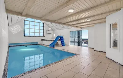 a swimming pool with a slide in a building at Stunning Home In Harboøre With Sauna in Harboør