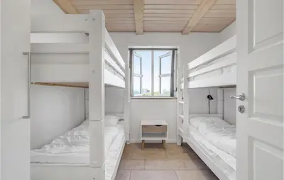 a room with two bunk beds and a window at Stunning Home In Harboøre With Sauna in Harboør