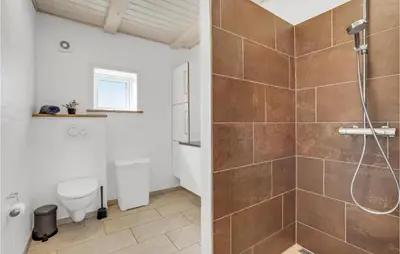 a bathroom with a shower and a toilet at Stunning Home In Harboøre With Sauna in Harboør