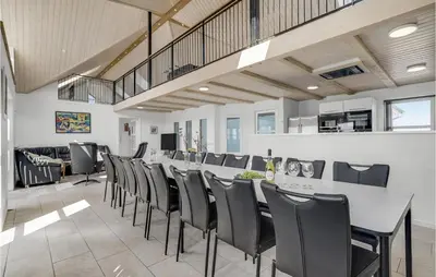 a dining room with a long table and chairs at Stunning Home In Harboøre With Sauna in Harboør