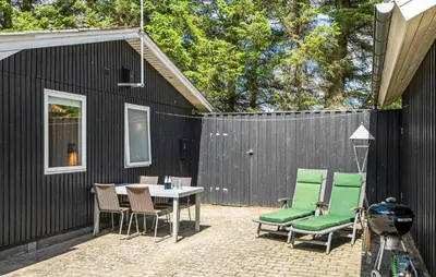 a patio with a table and chairs and a fence at Beautiful Home In Spøttrup With Kitchen in Spottrup