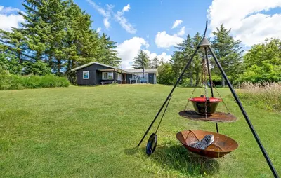 a swing in a yard with a house in the background at Beautiful Home In Spøttrup With Kitchen in Spottrup