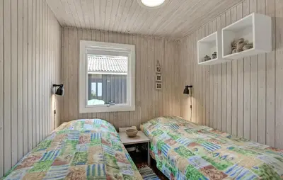 two beds in a room with a table and a window at Beautiful Home In Spøttrup With Kitchen in Spottrup