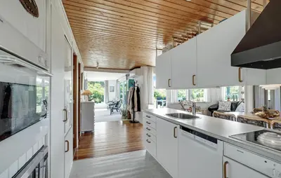 a kitchen with white cabinets and a wooden ceiling at Beautiful Home In Spøttrup With Kitchen in Spottrup
