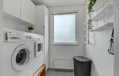 a laundry room with a washing machine and a window at Nice Home In Roslev With Kitchen in Roslev