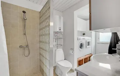 a bathroom with a shower toilet and a sink at Nice Home In Roslev With Kitchen in Roslev