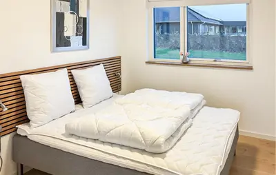 a white bed in a room with a window at Lovely Home In Spøttrup With Wifi in Spottrup