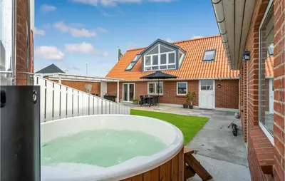 a bath tub in the backyard of a house at Amazing Home In Vestervig With Sauna in Vestervig
