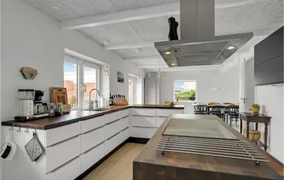 a kitchen with white cabinets and a counter top at Amazing Home In Vestervig With Sauna in Vestervig