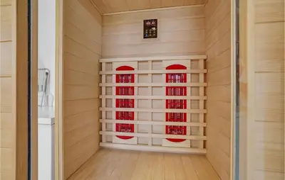 a japanese room with a wall of wine bottles at Amazing Home In Vestervig With Sauna in Vestervig