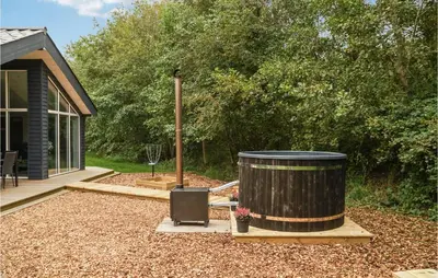 a large wooden barrel sitting in a yard at Nice Home In Hurup Thy With Wifi in Sindrup
