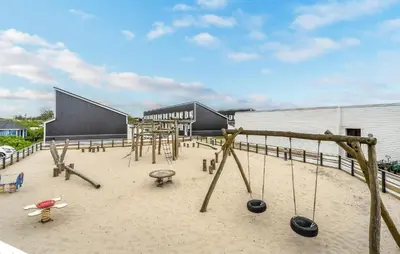 an outdoor playground with swings and swings at Awesome Apartment In Vestervig in Vestervig