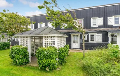 an exterior view of a black house with a yard at Awesome Apartment In Vestervig in Vestervig