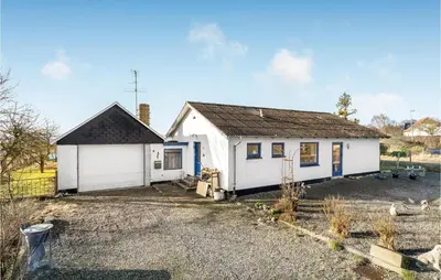 a white house with a black roof at Beautiful Home In Nykøbing M With Wifi in Sønder Dråby